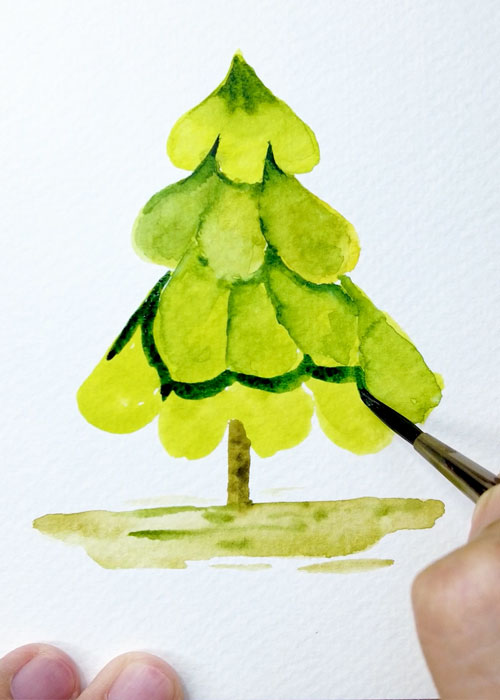 adding dark green shadows to a watercolor christmas tree painting